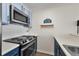 Efficient kitchen with stainless steel oven and cooktop plus overhead microwave at 100 S Park Ave # E312, Breckenridge, CO 80424
