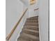 Carpeted staircase featuring a wooden handrail and natural light at 100 S Park Ave # E312, Breckenridge, CO 80424