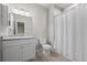 Clean bathroom with a single vanity, toilet and shower with curtain at 11250 Florence St # 28F, Commerce City, CO 80640