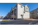 Modern multi-story home with neutral siding, stone accents, and a well-manicured lawn at 11250 Florence St # 28F, Commerce City, CO 80640