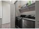 Functional laundry room with modern front-load washer and dryer at 11250 Florence St # 28F, Commerce City, CO 80640