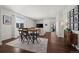 Open-concept living room with hardwood floors, dining area, and sliding glass doors to balcony at 11250 Florence St # 28F, Commerce City, CO 80640