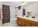 Clean and well-maintained bathroom featuring double sinks, shower-tub combination and a traditional design at 8095 Bannock Dr, Larkspur, CO 80118