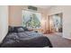 Comfortable bedroom with large windows offering natural light and closet with mirrored doors adding a touch of elegance at 8095 Bannock Dr, Larkspur, CO 80118