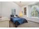 Cozy bedroom with plenty of natural light from large windows and a built-in shelf adding character and style at 8095 Bannock Dr, Larkspur, CO 80118