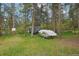 Backyard area features mature trees, storage and covered boat in a heavily treed area at 8095 Bannock Dr, Larkspur, CO 80118