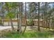 Charming exterior showcasing the home's architecture with a well-manicured lawn and mature trees at 8095 Bannock Dr, Larkspur, CO 80118