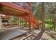 Exterior view of the painted wood deck with stairs leading to a lower concrete area at 8095 Bannock Dr, Larkspur, CO 80118