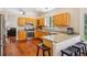 Well-lit kitchen featuring granite countertops, wooden cabinets, stainless steel appliances, and breakfast bar seating at 8095 Bannock Dr, Larkspur, CO 80118