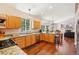 Bright kitchen with granite countertops, stainless steel appliances, and hardwood floors that create a warm atmosphere at 8095 Bannock Dr, Larkspur, CO 80118