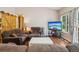 Inviting living room featuring hardwood floors, a large window, and stylish barn door accents at 8095 Bannock Dr, Larkspur, CO 80118