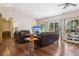 Comfortable living room with hardwood floors, large windows providing ample light, and vaulted ceilings at 8095 Bannock Dr, Larkspur, CO 80118