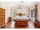 Spacious main bedroom with vaulted ceiling, hardwood floors, and lots of natural light, providing comfort and style at 8095 Bannock Dr, Larkspur, CO 80118