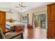 Bright main bedroom with vaulted ceilings, hardwood floors, ceiling fan, and private access to the backyard at 8095 Bannock Dr, Larkspur, CO 80118