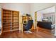 Cozy office area featuring hardwood floors, built-in bookshelves, and a comfortable workspace at 8095 Bannock Dr, Larkspur, CO 80118