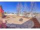 Well-maintained backyard with a fire pit, neat rock beds, and mature trees at 9912 Bradbury St, Firestone, CO 80504