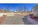 The backyard includes a utility shed, rock garden, and a white picket fence at 9912 Bradbury St, Firestone, CO 80504