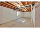 Unfinished basement area with concrete floor and exposed ceiling beams at 9912 Bradbury St, Firestone, CO 80504