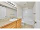 Bright bathroom featuring a single sink vanity and a shower-tub combo at 9912 Bradbury St, Firestone, CO 80504