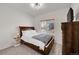 Comfortable bedroom with carpet floors features a large window and a wooden bed frame, creating a restful retreat at 9912 Bradbury St, Firestone, CO 80504