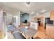 Open-concept dining space with modern table, seamlessly connected to kitchen and living areas at 9912 Bradbury St, Firestone, CO 80504