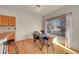 Bright dining area features hardwood floors and a window letting in natural light at 9912 Bradbury St, Firestone, CO 80504