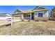 Charming home with stone accents, a well-manicured lawn, and a two-car garage at 9912 Bradbury St, Firestone, CO 80504