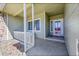 Inviting front porch with stone accents, white railings, and a view of the front door at 9912 Bradbury St, Firestone, CO 80504