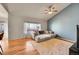 Cozy living room with hardwood floors, large windows, and a sectional sofa at 9912 Bradbury St, Firestone, CO 80504