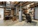 Unfinished basement with concrete floor, exposed utilities and water heater at 10843 W Hinsdale Dr, Littleton, CO 80127