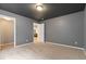 Spacious bedroom featuring neutral carpet, gray walls, and a modern ceiling light fixture at 10843 W Hinsdale Dr, Littleton, CO 80127