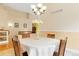 Elegant dining room with chandelier and staircase view at 10843 W Hinsdale Dr, Littleton, CO 80127