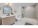 Stylish bathroom featuring modern fixtures, a shower-tub combo, and contemporary design elements at 902 Poplar St, Denver, CO 80220