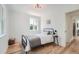 Simple bedroom featuring hardwood floors, bright natural light, and minimalist decor at 902 Poplar St, Denver, CO 80220