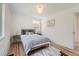 Comfortable bedroom featuring hardwood floors, neutral decor, and ample natural light through a large window at 902 Poplar St, Denver, CO 80220