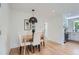 Cozy dining room adjacent to the kitchen with stylish light fixture and seating for four at 902 Poplar St, Denver, CO 80220