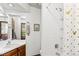 Bathroom featuring a white vanity, white tile shower and golden accents at 14271 E Dickinson Dr # F, Aurora, CO 80014