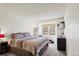 Bright bedroom featuring a window view, gray carpet, and comfortable sleeping arrangements at 14271 E Dickinson Dr # F, Aurora, CO 80014