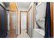 Hallway featuring a washer and dryer and access to the bathroom at 14271 E Dickinson Dr # F, Aurora, CO 80014