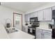 Traditional kitchen featuring gray cabinets, white countertops and modern appliances at 14271 E Dickinson Dr # F, Aurora, CO 80014