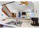 Open kitchen featuring a modern sink, breakfast bar, and a view into the living room at 14271 E Dickinson Dr # F, Aurora, CO 80014
