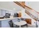 Modern kitchen with breakfast bar, gray cabinets, and staircase access at 14271 E Dickinson Dr # F, Aurora, CO 80014