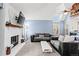 Cozy living room with a white brick fireplace and comfortable seating area at 14271 E Dickinson Dr # F, Aurora, CO 80014