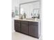 Bathroom features a gray vanity, granite countertop, a large mirror, and great lighting at 19503 W 58Th Pl, Golden, CO 80403