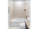 A well-lit bathtub and shower area with tiled walls and bronze fixtures enhancing a spa-like feel at 19503 W 58Th Pl, Golden, CO 80403