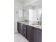 Bathroom vanity features dual sinks with granite countertops and dark cabinets for a sleek design at 19503 W 58Th Pl, Golden, CO 80403