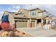 Inviting home with a well-manicured lawn, three-car garage, solar panels, and a cozy front porch at 19503 W 58Th Pl, Golden, CO 80403