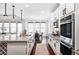 Bright kitchen features granite counters, stainless appliances, large island, and flows into the dining area at 19503 W 58Th Pl, Golden, CO 80403