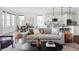 Living room flowing into the kitchen with an open floorplan, modern decor, and lots of natural light at 19503 W 58Th Pl, Golden, CO 80403