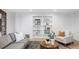 Bright living room featuring stylish sectional, decorative rug, and built-in bookshelves for organized living at 19503 W 58Th Pl, Golden, CO 80403